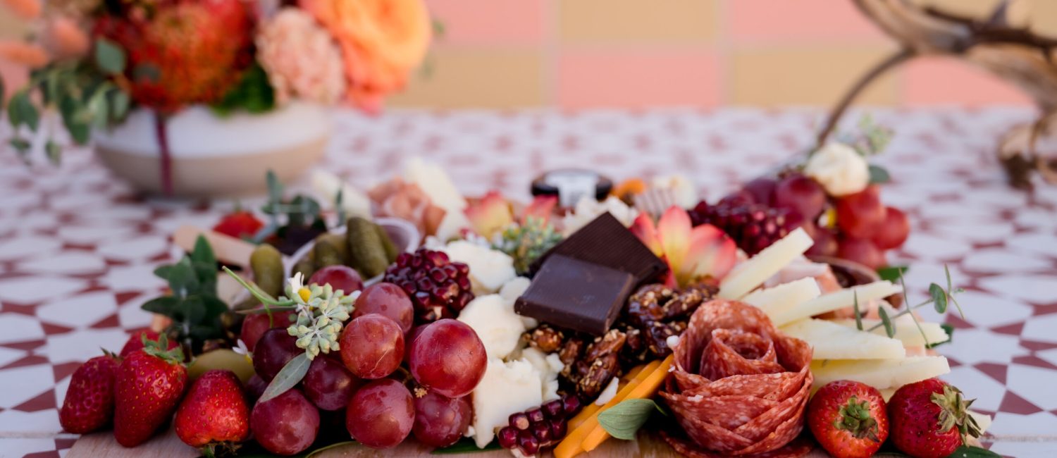 Charcuterie picnic board with meats cheeses and chocolate colorf